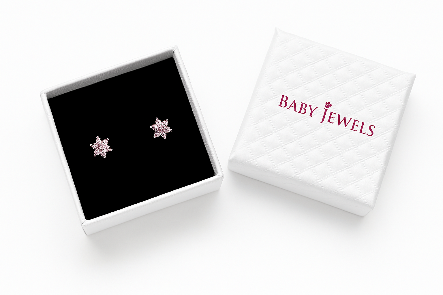 Star-shaped earrings in a 'Baby Jewels' box on a white background