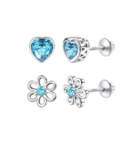 Pair of silver earrings with blue gemstones on a white background