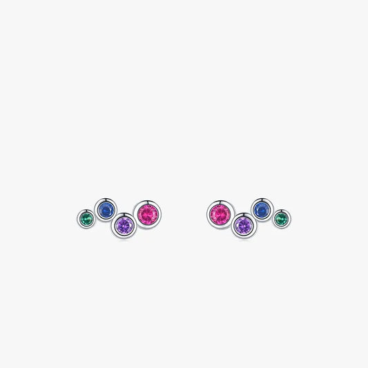 A pair of sterling silver earrings with bezel set colored CZs in blue, pink, green, and purple, designed for babies and children with push back closures.