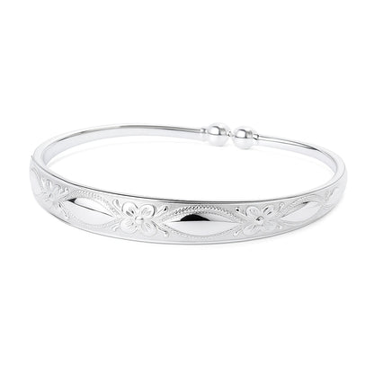Children's bangle - silver plated embossed cuff featuring floral design and elegant finish.