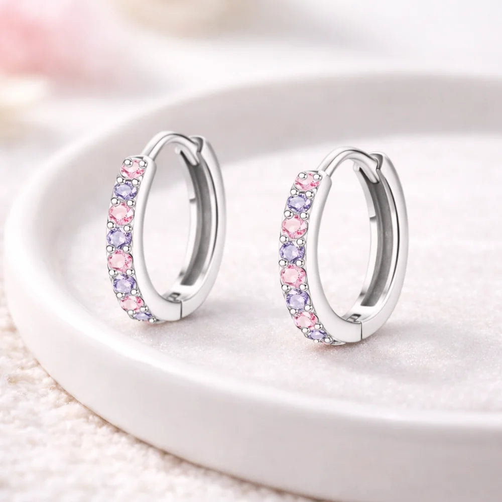 Children's earrings in 316L surgical steel with pink and purple CZ huggie hoops, perfect for kids and teens.
