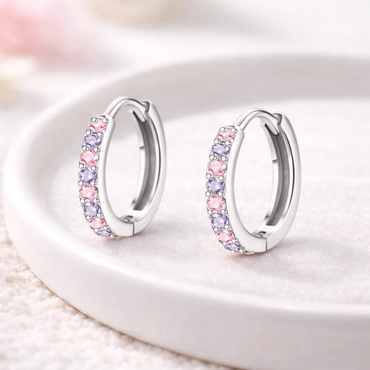 Children's earrings in 316L surgical steel with pink and purple CZ huggie hoops, perfect for kids and teens.