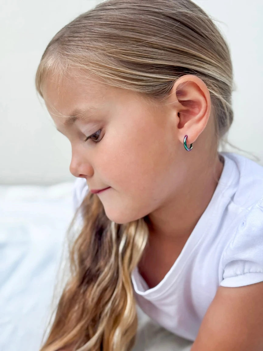 Child's profile showing colorful children's earrings, anodised 316L surgical steel rainbow hoops in 10mm size.