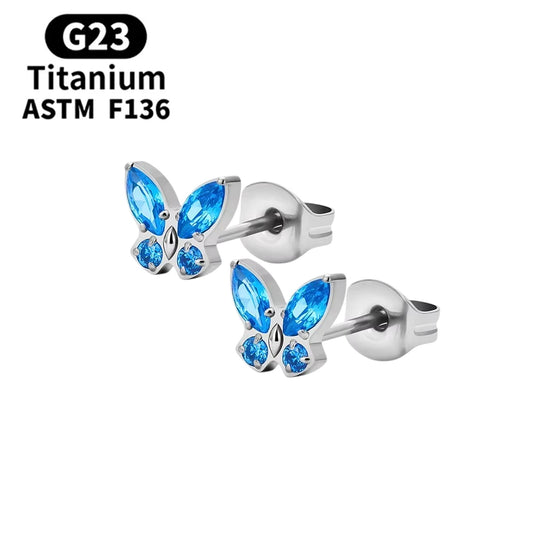 Children's earrings featuring blue CZ crystal butterfly studs made from G23 titanium.