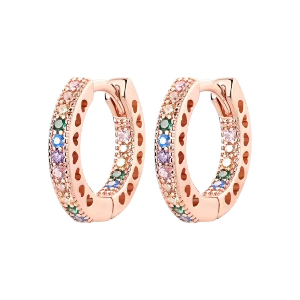 Children's earrings featuring rose gold plated sterling silver huggie hoops with rainbow CZ stones.
