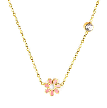 Daisy necklace featuring a pink enamel daisy pendant and clear CZ accent on a gold chain.