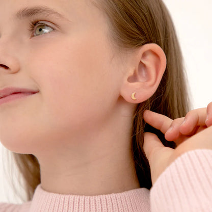Girl wearing gold moon earrings with secured screw backs, showcasing elegant 14k solid gold design.