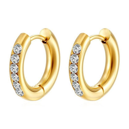 A pair of gold plated hypoallergenic steel huggie hoop earrings with clear cubic zirconia accents.
