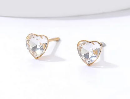 close-up of children’s gold plated surgical steel with Cubic Zirconia heart earrings with pushbacks