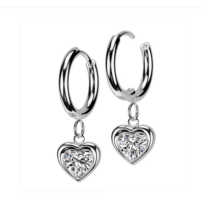 Heart hoop earrings featuring sparkling cubic zirconia heart charms in hypoallergenic surgical steel.