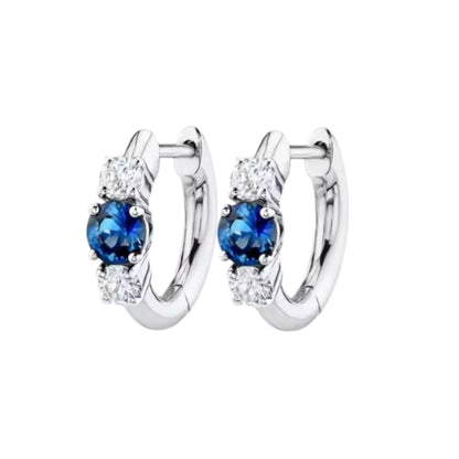 Huggie hoop earrings made of 925 sterling silver with blue and white cubic zirconia stones, perfect for any occasion.