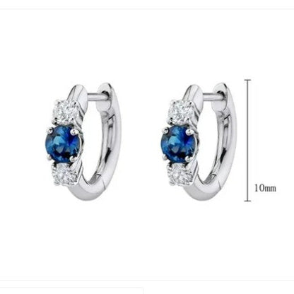 Huggie hoop earrings made of 925 sterling silver featuring blue and white cubic zirconia, elegant and hypoallergenic.