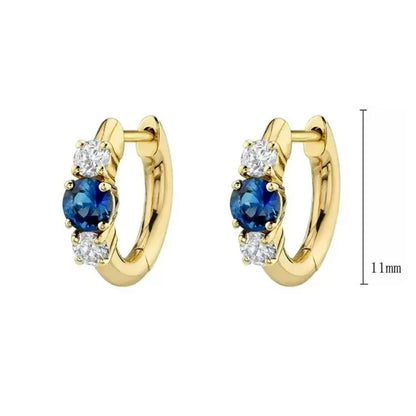 Huggie hoop earrings featuring sparkling blue and white cubic zirconia in solid 925 sterling silver.