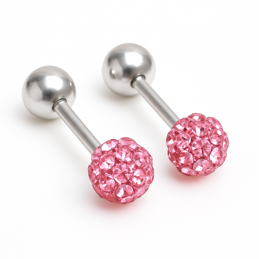 A pair of baby and children's earrings with screw back closures, featuring a reversible pink crystal ball design.