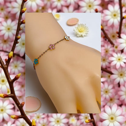 Sweet Spring Blooms Bracelet for Girls – Hypoallergenic Surgical Steel bracelet displayed on a hand with floral background.