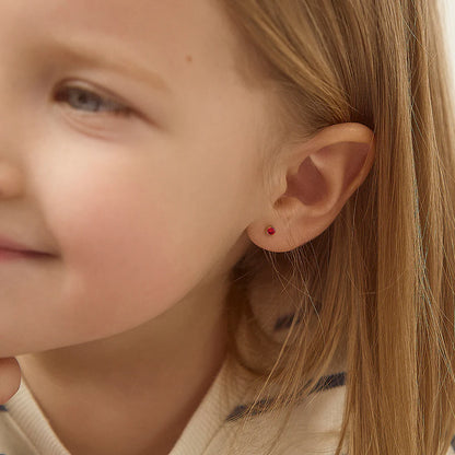 January Birthstone Earrings for babies & children featuring 3mm garnet CZ stud earrings in 14k gold.
