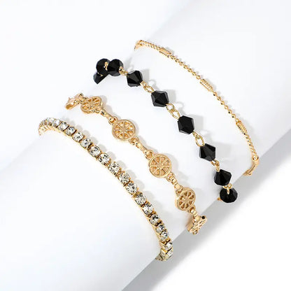 Layered bracelet set with black crystals and gold accents, perfect for versatile and chic styling.