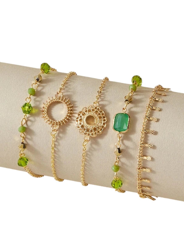 Layered bracelet set featuring three green crystal bracelets on display, perfect for a chic layered look.