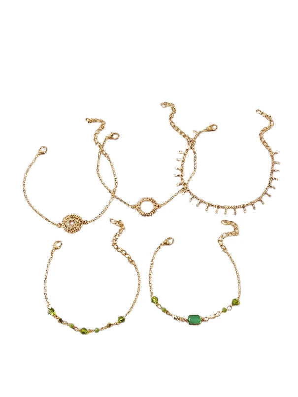 Layered bracelet set featuring gold chains and green accents for a trendy layered look.