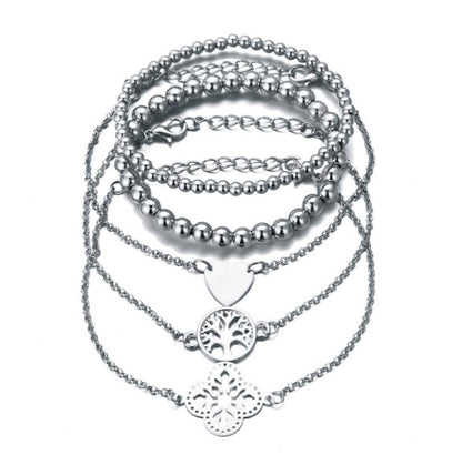 Layered bracelet set featuring three stylish bracelets with tree of life accents, ideal for chic layered looks.