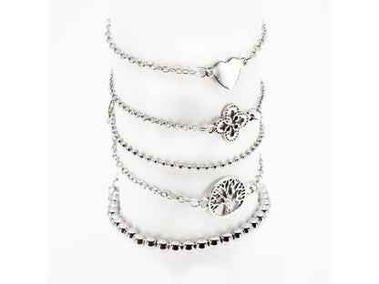 Layered bracelet set featuring three bracelets with tree of life accents, perfect for chic layered looks.