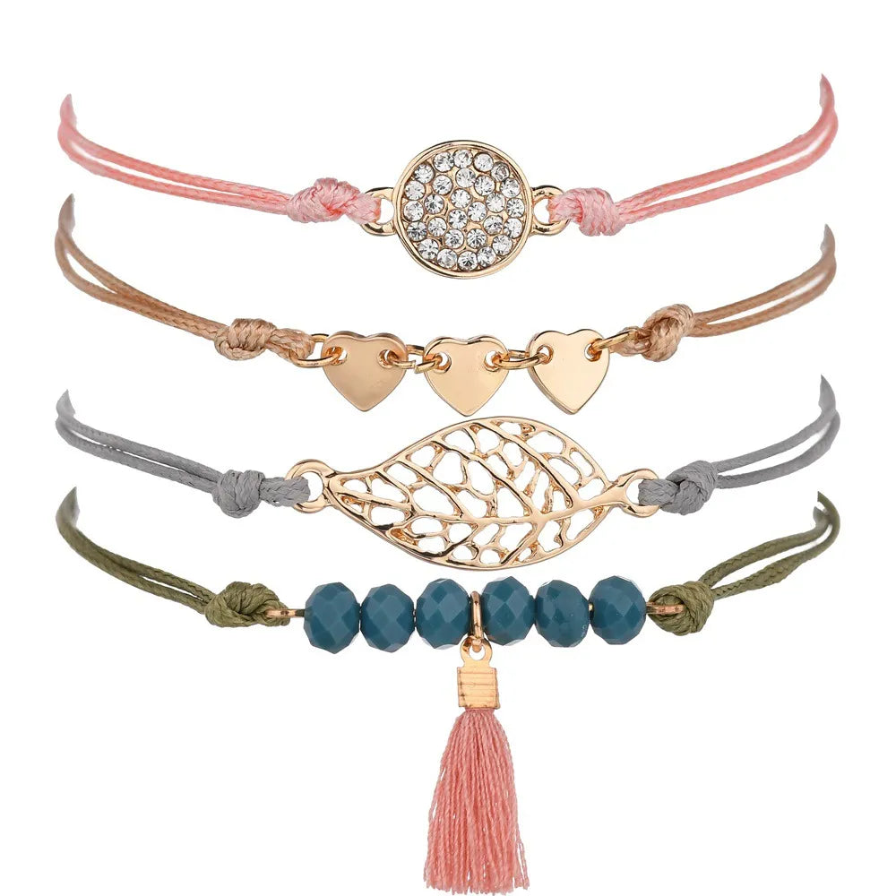 Layered bracelet set featuring four bohemian cord bracelets perfect for chic layered looks.