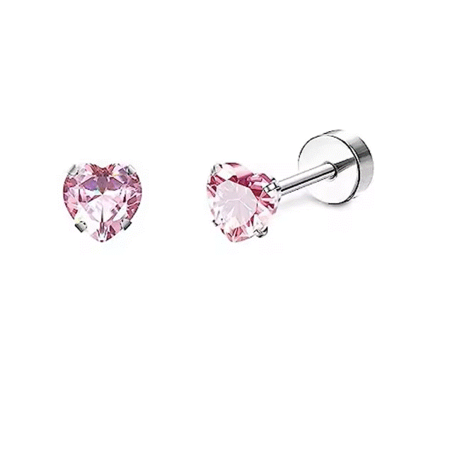 Two heart‑shaped pink cubic zirconia stud earrings on a white background; the left earring is shown face‑on with its faceted pink stone held by four slender silver prongs, and the right earring is angled to reveal its thin sterling‑silver post with partial threading and a smooth screw‑back disc