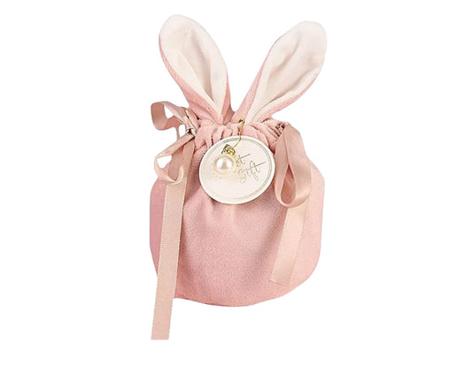 A pink velveteen gift bag with rabbit ears and a bow, designed for holding jewellery or other gifts on a white background