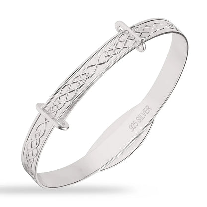 Sterling silver children’s expandable bangle with engraved infinity/Celtic-knot pattern along the band, polished finish, and “.925 SILVER” stamped inside, shown on a white background.