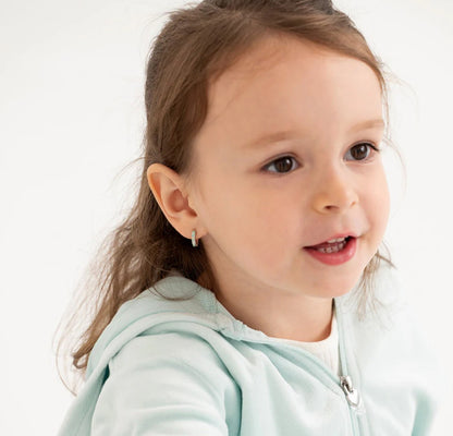 lifestyle image featuring a young girl wearing sterling silver huggie hoops with opal inlay.