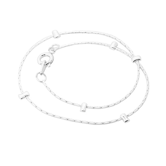 Children's anklet made of silver plated material featuring decorative studs and a secure clasp for everyday wear.