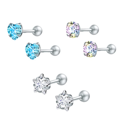 A set of children's earrings featuring various shapes and colours including a blue heart, a clear star, and a multi-coloured round cz, all with screw back closures.