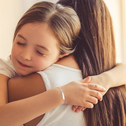 Child wearing sterling silver Figaro ID bracelet, showing perfect fit and shine