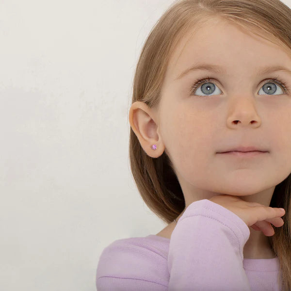 Young girl wearing pink heart CZ earrings - lifestyle image showing sparkle and style