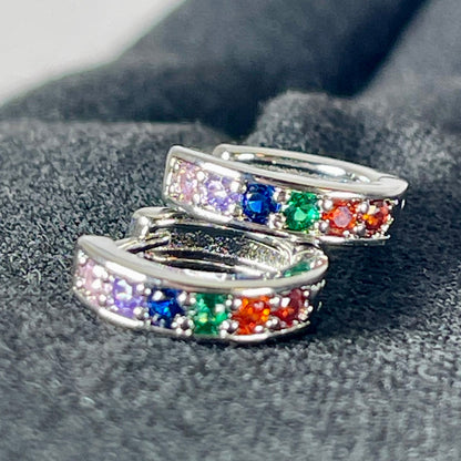 Rainbow CZ huggies featuring vibrant multi-colour cubic zirconia stones in polished surgical steel for children.