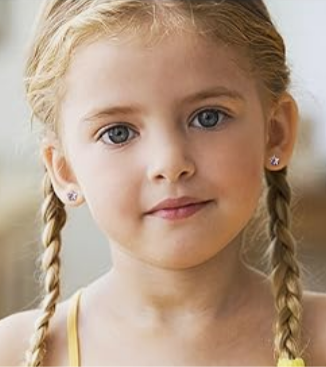 a young girl with blonde hair in plaits with star shaped cubic zirconia studs in her ears