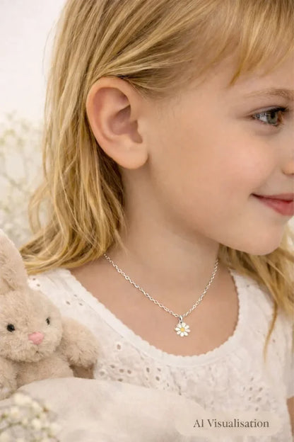 Children's necklace featuring a daisy pendant worn by a smiling girl with long hair.