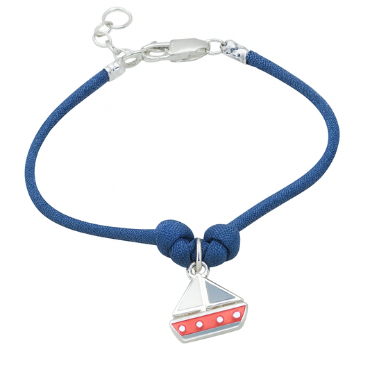 Blue cord bracelet with a sailboat charm on a white background