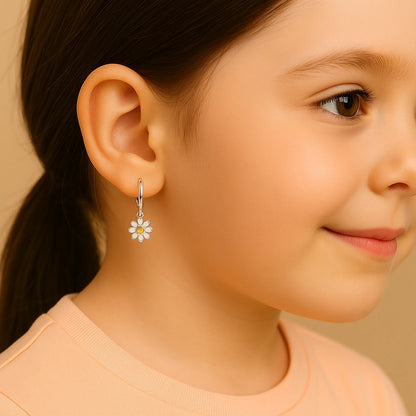 Girl wearing daisy charm hoop earrings made of 925 sterling silver, highlighting charm and style for ages 5 and up.