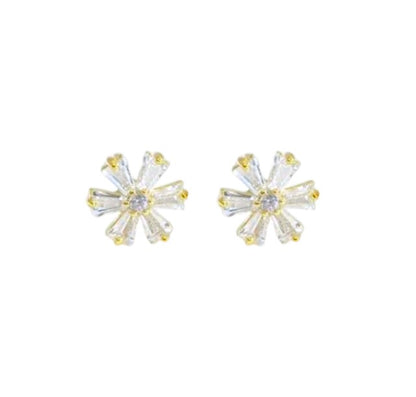 Pair of gold and clear crystal stud earrings on a white background
