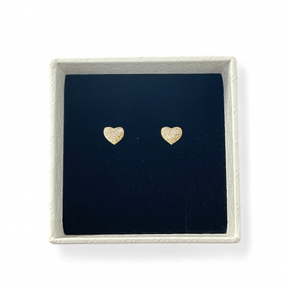 Heart-shaped gold earrings in a jewelry box on a white background