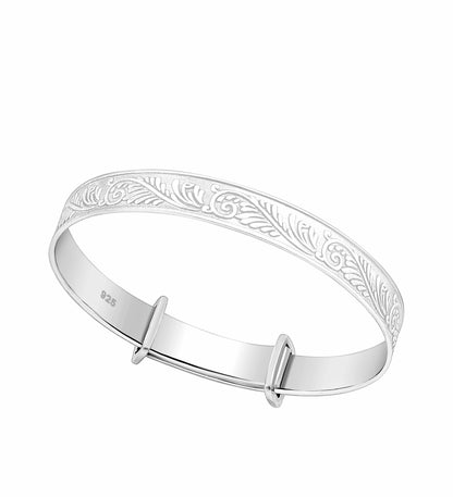 A sterling silver bangle with an unfurling fern leaf design, suitable for children, displayed against a white background.