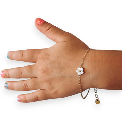 Children's bracelets featuring a delicate clear CZ flower charm on an adjustable chain worn on a child's hand.