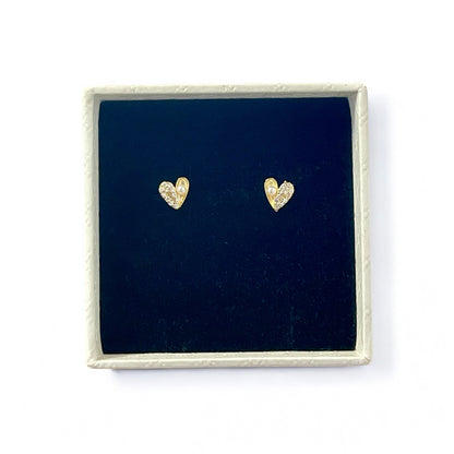 Gold heart-shaped earrings in a white gift box with black velvet lining