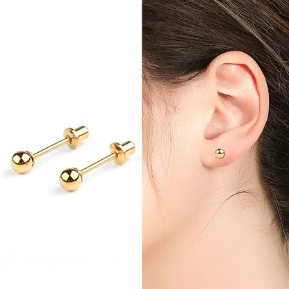 split image with A pair of polished surgical steel 4mm ball stud earrings with screw backs and yellow gold ionic plating on the left and a close up of the ball studs in the ear of a young girl on the right