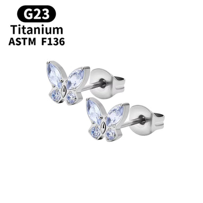 Children's earrings with butterfly design, featuring sparkling purple CZ stones and made from G23 titanium.