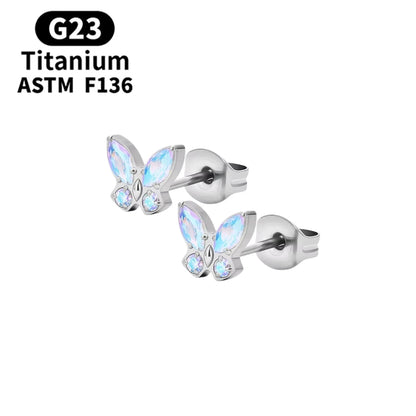 Children's earrings featuring opalite aurora CZ butterfly studs made from G23 titanium.