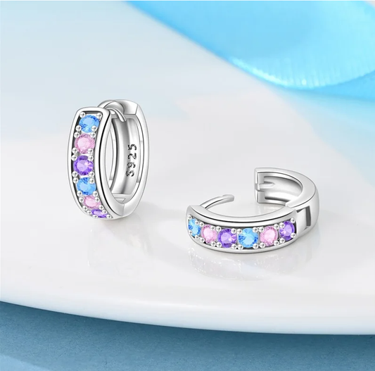 Colourful kids huggie hoop earrings in sterling silver displayed on white background