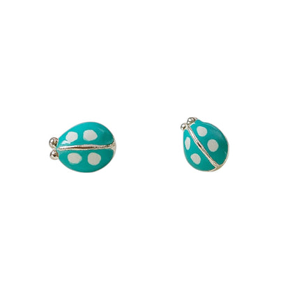 Turquoise ladybug earrings with white polka dots on a white background