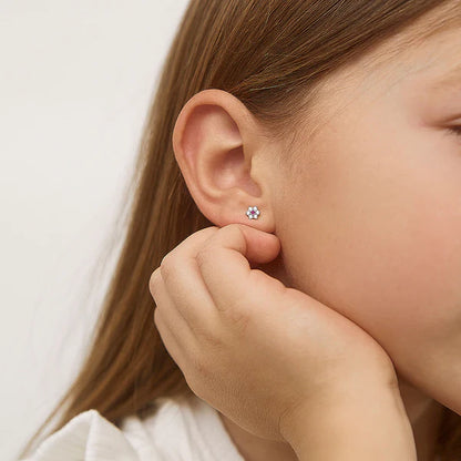 Multicolour CZ Flower Earrings on a young girl's ear, showcasing the sparkling design of these sterling silver kids' earrings.